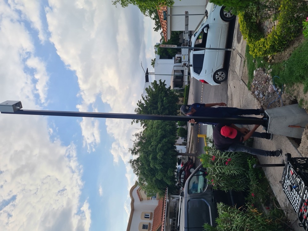 Técnicos instalando poste para cámara de videovigilancia